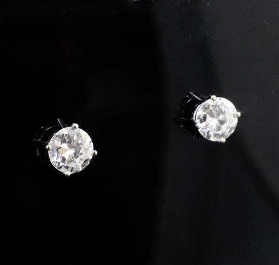 A pair of 14ct white gold and solitaire diamond ear studs,